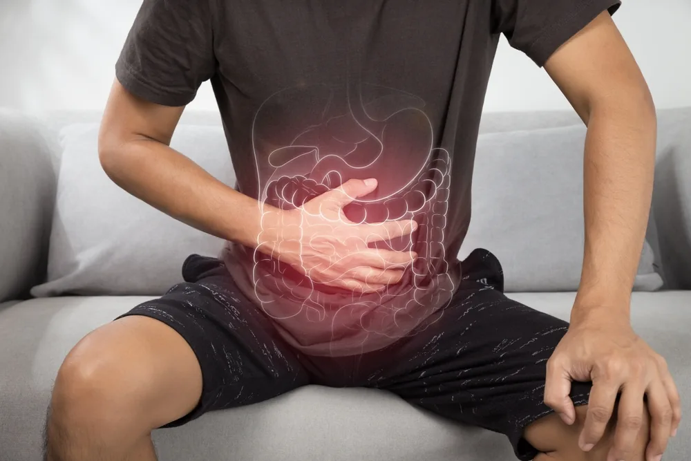 A seated figure with the digestive tract drawn over the abdomen