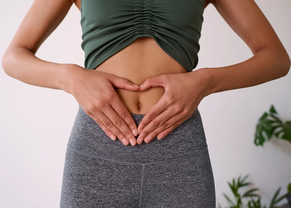 A person framing their abdomen with both hands
