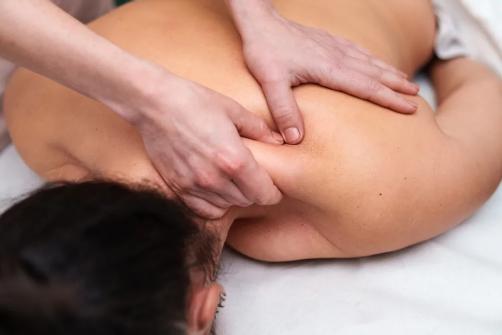 Hands working across the neck and shoulder