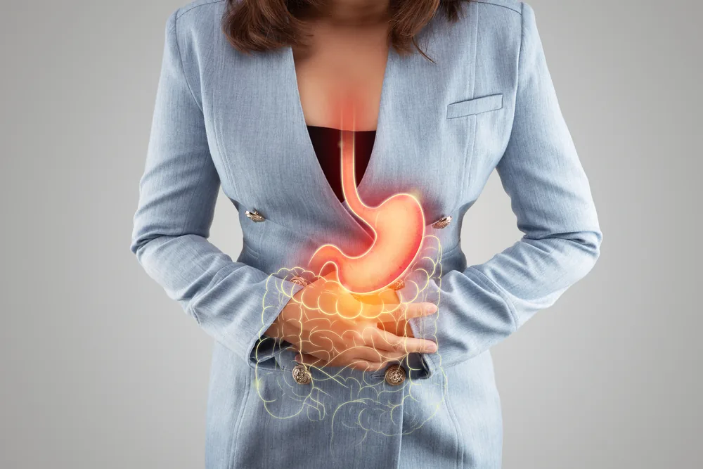 A woman with the stomach and intestines drawn over her abdomen